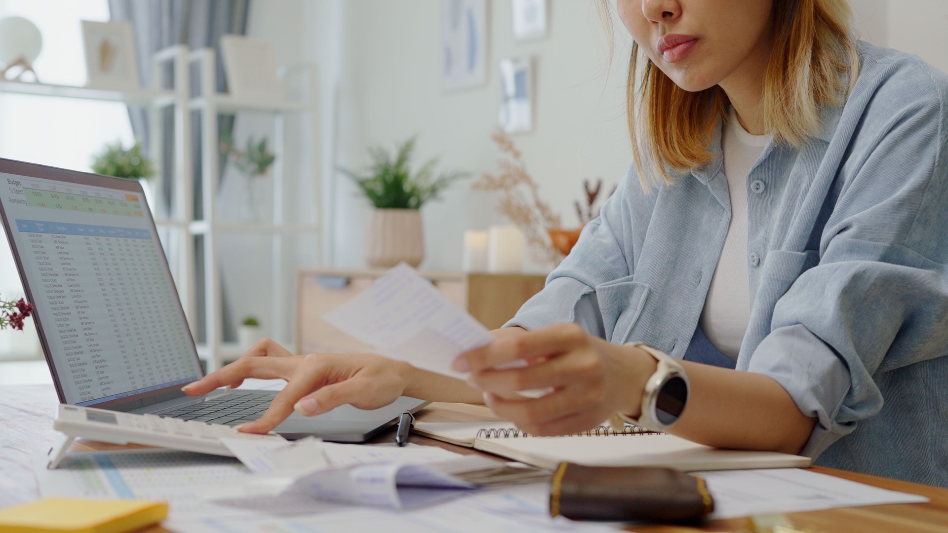 close up  woman hands calculates on calculator for personal finance, paysckeck paper receipt expense biil statement,planning budgets of monthly personal balance at home.